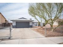 Charming single-story home with a well-maintained front yard and attached garage at 815 Center St, Henderson, NV 89015