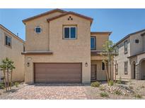 Charming two-story home with a brick driveway and a two-car garage in a well-maintained neighborhood at 9825 Lost Horse Ave, Las Vegas, NV 89178