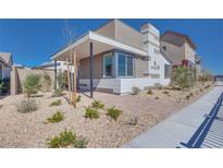 A modern home showcasing a stylish exterior with patterned accents and low-maintenance landscaping at 990 Golden Summit Dr, Las Vegas, NV 89138