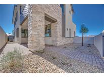 Inviting two-story home with stone accents and landscaped front yard at 991 Golden Summit Ave, Las Vegas, NV 89138