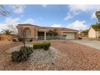 Charming single-story home featuring manicured landscaping and a two-car garage at 9917 Arbuckle Dr, Las Vegas, NV 89134