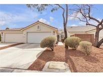 Charming single-story home featuring a well-manicured front yard and an attached two-car garage at 10035 Oak Creek Canyon Ave, Las Vegas, NV 89147