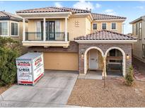Charming two-story home with a balcony, stone accents, and a well-maintained front yard at 1309 Rainy Sky Ave, North Las Vegas, NV 89030