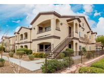 Inviting two-story condo with brown trim and appealing landscaping at 2291 W Horizon Ridge Pkwy # 6136, Henderson, NV 89052