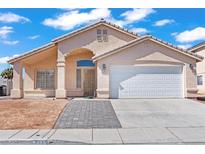 Charming single-story home featuring a well-maintained lawn, two-car garage, and inviting covered front porch at 2419 Country Orchard St, North Las Vegas, NV 89030