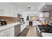 Well-lit kitchen featuring stainless steel appliances, white cabinets, and an undermount sink at 3961 Tirana Way, Las Vegas, NV 89103