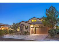 Charming home featuring a stone facade, tile roof, attached two-car garage, and well-manicured landscaping at 79 Rezzonico Dr, Henderson, NV 89011