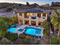 Aerial view of a private backyard pool with a spa, patio furniture and upper balcony at 79 Rezzonico Dr, Henderson, NV 89011
