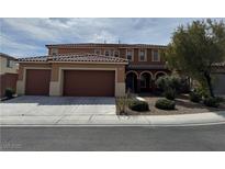 Charming two-story home featuring a three-car garage and well-manicured landscaping, offering curb appeal at 1633 Dornie Ave, North Las Vegas, NV 89084