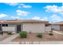Cozy single-story home featuring a stucco exterior, desert landscaping, and a tile roof against a blue sky at 255 N Lamb Blvd # F, Las Vegas, NV 89110