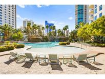 Beautiful resort-style pool with sandy beach area and palm trees surrounded by high-rise buildings at 322 Karen Ave # 1507, Las Vegas, NV 89109