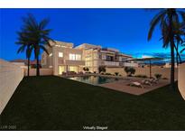 An inviting backyard featuring a modern pool, lounge chairs, and lush green lawn, perfect for outdoor relaxation at 3980 Heron Fairway Dr, Las Vegas, NV 89141