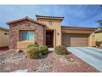 Charming single-story home featuring a stone accent wall, desert landscaping, and a two-car attached garage at 4780 Lorenzo Way, Pahrump, NV 89061