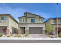 Two-story home featuring a two-car garage, desert landscaping, and modern architectural details at 8866 Mountain Lion Ave, Las Vegas, NV 89166