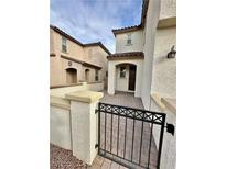 Charming home featuring a gated front porch and a beautifully landscaped entrance at 346 Andy Wheeler Dr, Henderson, NV 89011