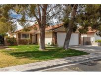 Charming single-story home featuring a well-manicured front yard, a two-car garage, and stone veneer accents at 4629 Winfield Dr, Las Vegas, NV 89147