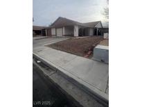 Traditional single-story home featuring a two-car garage and a covered carport at 4868 Treetrunk Ave, Las Vegas, NV 89147