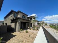 Charming home with desert landscaping, covered entry, and walkway to other units at 492 Pear Lake St, Las Vegas, NV 89138
