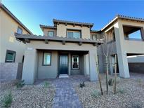 Charming home exterior featuring desert landscaping and a welcoming covered entryway and a stone tile walkway at 492 Pear Lake St, Las Vegas, NV 89138