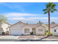 Charming single-story home featuring stucco exterior, desert landscaping, and a classic tile roof at 4932 Forest Oaks Dr, Las Vegas, NV 89149