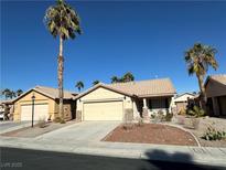 Charming single-story home features a tile roof, desert landscaping and a two-car garage at 5034 Sail Rock Pl, North Las Vegas, NV 89031