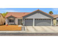 Charming single-story home featuring a terra cotta roof, two-car garage, and low-maintenance landscaping at 5227 Zebra Ct, North Las Vegas, NV 89031