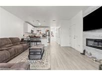 Cozy living room with modern fireplace, sleek floors, and an open layout connected to the kitchen at 5415 W Harmon Ave # 1074, Las Vegas, NV 89103