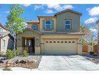 Charming two-story home featuring a well-maintained front yard and a spacious two-car garage at 5808 Sierra Cliff St, North Las Vegas, NV 89031