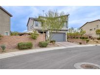 Charming two-story home featuring a gray garage door, brick accents, and a well-maintained front yard at 5981 Smith Valley Rd, Las Vegas, NV 89148