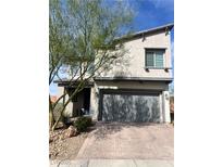 Charming two-story home with landscaped front yard and a paved driveway leading to a two-car garage at 5981 Smith Valley Rd, Las Vegas, NV 89148