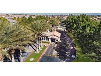 View of the community gate, lush landscaping, guard house, and secure entry at 11072 Pentland Downs St, Las Vegas, NV 89141