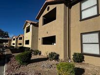 Exterior view of a multi-unit building with tan siding and landscaped grounds at 2451 N Rainbow Blvd # 1156, Las Vegas, NV 89108