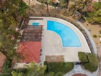 Aerial view of a community pool with a pergola covered patio and sunning deck at 2517 Balintore Ct, Henderson, NV 89014