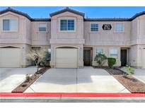 Charming townhome featuring a private garage and well-maintained front landscaping at 2621 Adelante Ave # 104, Las Vegas, NV 89106