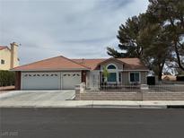 Charming single story home with an attached three car garage, tile roof, and neutral-tone exterior at 3316 Cutty Sark St, Las Vegas, NV 89117