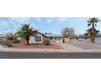 Charming single-story home featuring desert landscaping, a long driveway, and palm trees at 420 Altamira Rd, Las Vegas, NV 89145