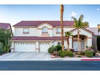 Inviting two-story home with a three-car garage, desert landscaping, and a red tile roof at 442 Beardsley Cir, Henderson, NV 89052