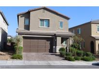 Two-story home featuring a brick driveway, neutral stucco, and an attached two-car garage at 7022 Judith River St, North Las Vegas, NV 89084