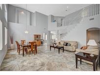Bright living room with soaring ceilings, neutral decor, and open floor plan at 851 Brunellos Ave, Las Vegas, NV 89123
