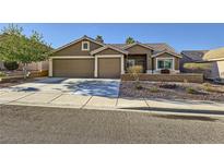 Inviting single-story home featuring a two-car garage and desert landscaping for low maintenance living at 917 Pigeon Forge Ave, Henderson, NV 89015