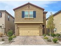 Charming two-story home with a two-car garage and desert landscaping at 9327 Ettrick Ct, Las Vegas, NV 89178