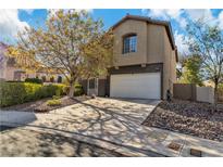 Inviting two-story home featuring a well-kept lawn, mature tree, and attached two-car garage at 9768 Northern Dancer Dr, Las Vegas, NV 89117