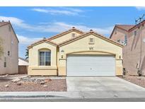 Charming one-story home featuring a well-maintained front yard, desert landscaping, and a two-car garage at 100 Beaver Falls Ave, Las Vegas, NV 89123