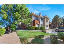 Inviting condo showcases mature trees, green lawn, assigned parking, and well-maintained landscaping at 1012 Domnus Ln # 105, Las Vegas, NV 89144