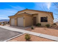 Charming single-story home featuring a two-car garage and low-maintenance desert landscaping in a sunny setting at 260 Haley Way # 157, Mesquite, NV 89027