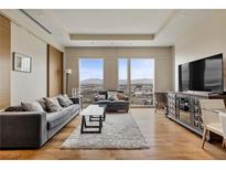 Modern living room with plush seating, city views, and hardwood floors at 3750 Las Vegas Blvd # 3510, Las Vegas, NV 89158