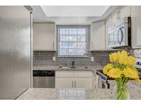 Modern kitchen with gray subway tile backsplash and granite countertops at 3823 S Maryland Pkwy # T8, Las Vegas, NV 89119