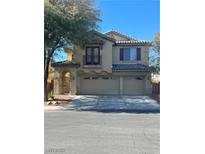 Charming two-story home with a three-car garage, decorative shutters, and a small balcony on the second story at 5937 Armide St, North Las Vegas, NV 89081