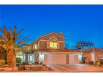 Charming two-story home with a well-manicured front yard and a three car garage at 6129 Flaming Arrow Rd, North Las Vegas, NV 89031