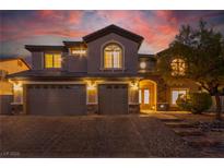 Beautiful two-story home with a three-car garage and meticulously maintained landscaping at 7338 Flying Pegasus Ct, Las Vegas, NV 89131